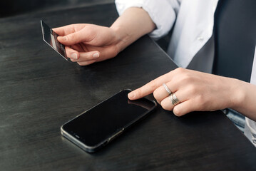 Online Shopping at Your Fingertips. Female Hands with Credit Card and Smartphone. Seamless E-commerce Experience. Female Hands Shopping with Credit Card and Smartphone.