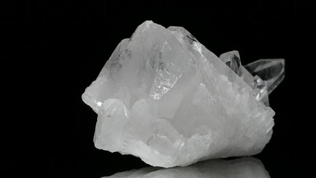 Clear Quartz crystals specimen rotating slowly against a black background.