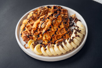Waffle, banana, chocolate topped with walnuts