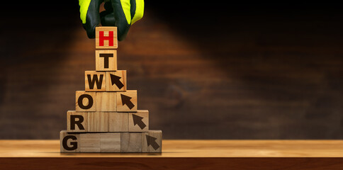 Fototapeta premium Gloved hand arranging wood blocks with text Growth and arrows symbol, above a wooden table or desk with copy space.