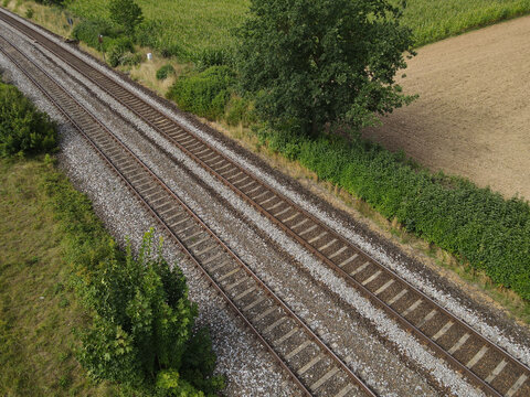 Railroad tracks in the landscape - Powered by Adobe