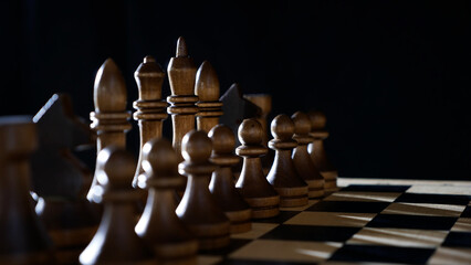 chess pieces on a chessboard. Black background