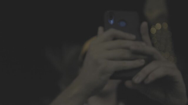 Seoul, South Korea - September, 09, 2023: a young man takes a close-up photo on his phone at night