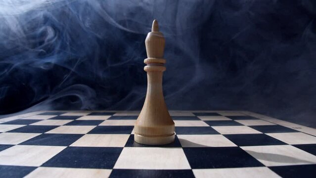 chess pieces on a chessboard. The king in the smoke. Loneliness, mysticism