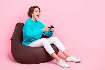 Photo of pretty glad girl sitting chair rejoice win competition playstation look empty space...
