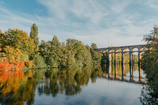 Railway Bridge with river in Bietigheim-Bissingen, Germany. Autumn. Railway viaduct over the Enz River, built in 1853 by Karl von Etzel on a sunny summer day. Bietigheim-Bissingen, Germany. Old