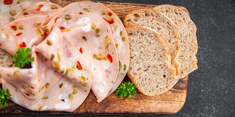 mortadella slice tasty sausage vegetable, olive, pickled cucumber, pepper, gherkin eating cooking appetizer meal food snack on the table copy space food background rustic top view © Alesia Berlezova