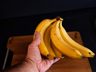 yellow bananas  on wooden table