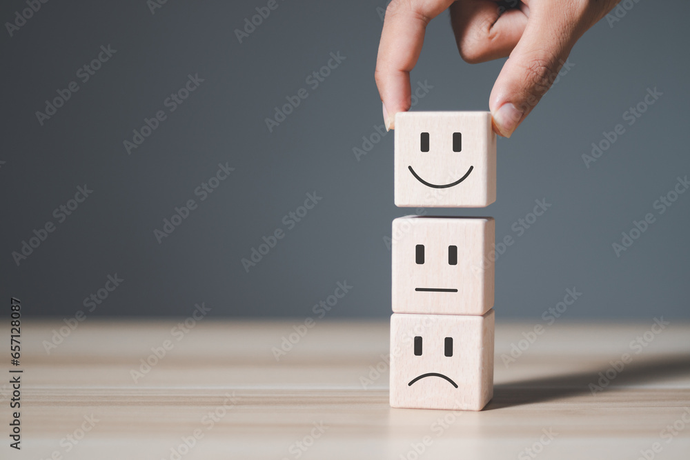Poster customer satisfaction service concept. businessman choosing wooden block with smiling face. satisfac