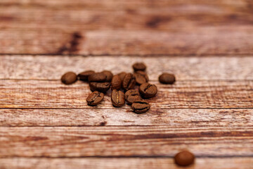 A handful of coffee beans scattered across the table.