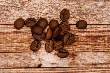 A handful of coffee beans scattered across the table.