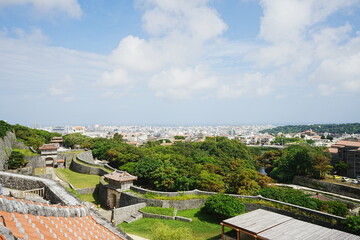 Fototapeta na wymiar Aerial view of Naha city and sea shore from Shurijo castle in Okinawa, japan. Panorama - 沖縄 那覇市の街並みと海 