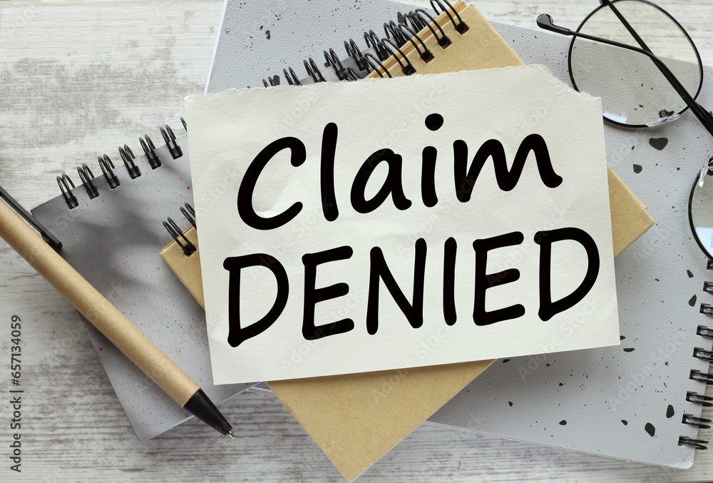 Poster claim denied. text on paper on a notepad on the table