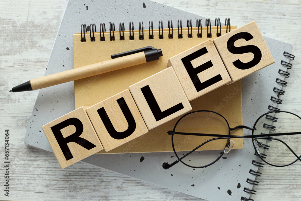 Poster view from above. close-up of the word on a wooden cube on a wooden table background - rules