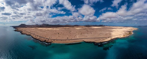 Poster Panoramic high angle aerial drone view of Corralejo National Park (Parque Natural de Corralejo) with sand dunes located in the northeast corner of the island of Fuerteventura, Canary Islands, Spain. © daliu