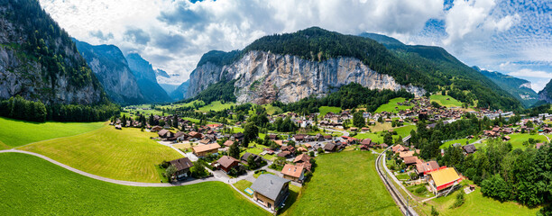 Lauterbrunnen valley with famous church and Staubbach waterfall. Lauterbrunnen village, Berner Oberland, Switzerland, Europe. Spectacular view of Lauterbrunnen valley in a sunny day, Switzerland.