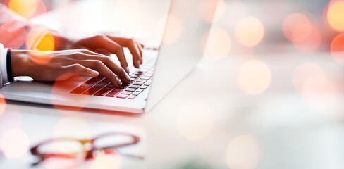 Laptop, hands and business woman by bokeh in office with document working on accounting budget project. Technology, research and closeup of professional accountant typing on computer in workplace.