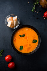 Fresh pumpkin cream soup with mint, spices and bread.