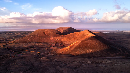 Drone shot over the mountains from the volcano Calderón Hondo at sunset on the island of Fuerteventura in Spain
