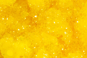 Golden crystal mineral stone. Gems. Mineral crystals in the natural environment. Texture of precious and semiprecious stones. Seamless background with copy space.