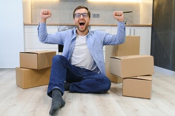 Smiling guy moving into his new home