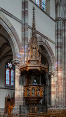 Naklejka premium Obernai, France - 09 07 2023: View of the pulpit inside the St. Martin's Church.