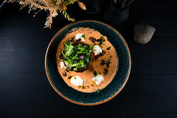 Baked stuffed peppers with meat, vegetables, cream cheese, herbs and sauce.