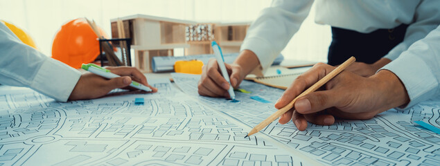 Worker, architect and engineer work on real estate construction project oratory planning with...