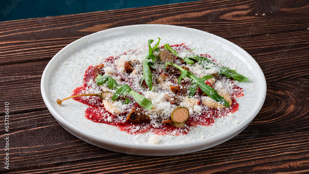 Canvas Prints cold appetizer of beef carpaccio with capers, parmesan cheese and arugula.