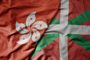 big waving realistic national colorful flag of hong kong and national flag of basque country .