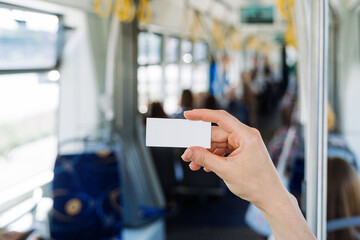 Ticket with copy space against blurred indoors public transport background