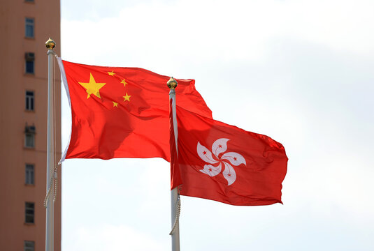 Chinese and hong kong flag set up in the event for celebrating the National Day of the People's Republic of China 74 th anniversary against the blue sky