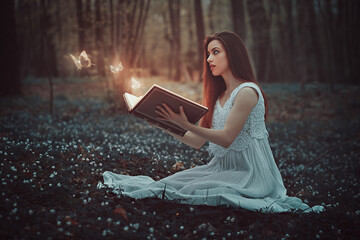 Beautiful girl opens a magical book