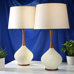 Pair of vintage stylish white lamps. Interior product photograph with a blue background.