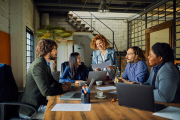 Young and diverse group of designers having a meeting in an office while working in a startup...