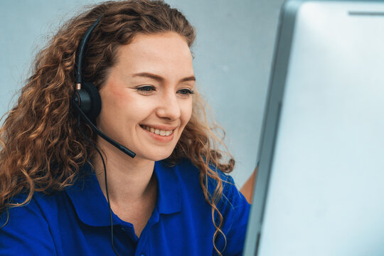 Business people wearing headset working in office to support remote customer or colleague. Call center, telemarketing, customer support agent provide service on telephone video conference call. Jivy