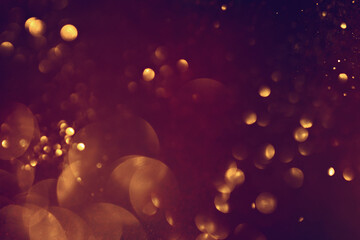 Golden abstract bokeh on black background. Celebrating Christmas, New Year or other holidays.