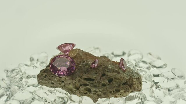 .Pink amethyst diamonds on raw opal lump The colors of the gems shone brilliantly, .creating a beautiful contrast in the light. .The gems were expertly crafted, making them a rare and valuable find.
