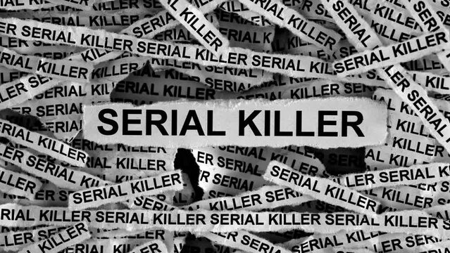 Strips of newspaper with the words Serial Killer typed on them. Black and white. Close up.