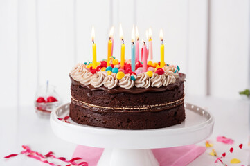 birthday cake with candles on a light background. Chocolate cake with cream