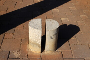 A row of pillars along the road for the safe passage of pedestrians along the sidewalk.