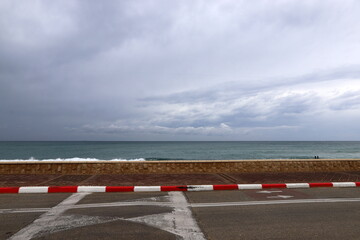A row of pillars along the road for the safe passage of pedestrians along the sidewalk.
