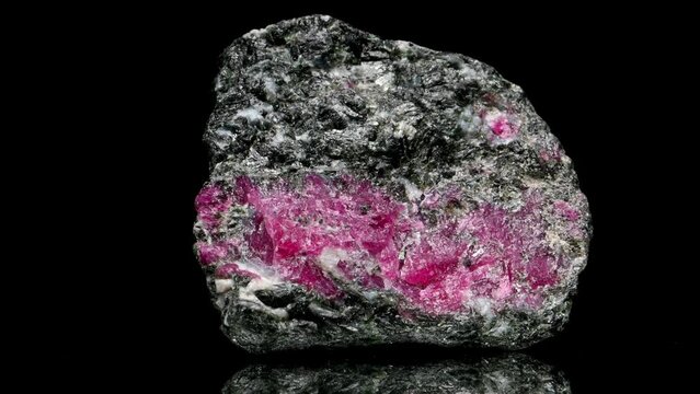 Anyolite (Ruby crystals in Zoisite) specimen rotating slowly against a black background.
