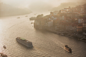 Aerial view of Porto cityscape in sunset with the river Douro and water vehicles - obrazy, fototapety, plakaty