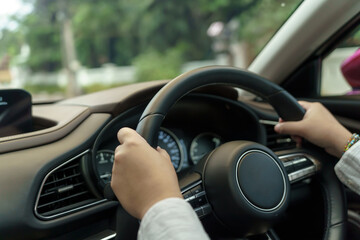 Woman driving car. girl feeling happy to drive holding steering wheel and looking on road