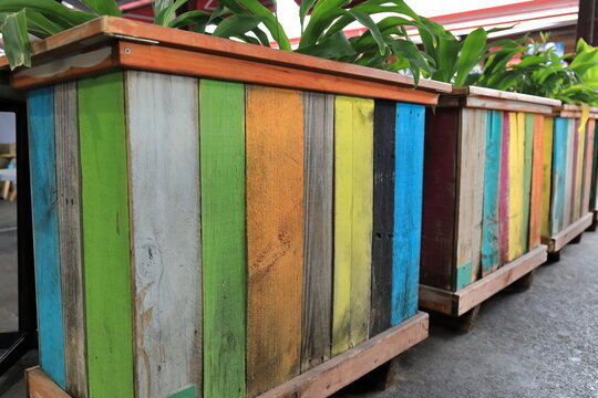 Multicolor planter boxes made of wooden pallets of the Australian standard dimensions in Queen Victoria Market. Melbourne-VIC-976