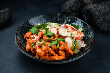 Fried chicken fillet in honey sauce and fresh vegetable salad with cucumber, radish, tomato.