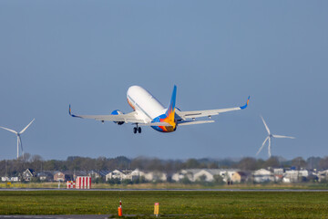 Fototapeta na wymiar Passenger plane taking off from the runway, Schiphol, Amsterdam, The Netherlands