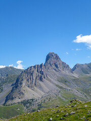 Naklejka premium Scenic mtb trail with view of Rocca La Meja near rifugio della Gardetta on the Italy French border in Maira valley in the Cottian Alps, Piedmont, Italy, Europe. Hiking on sunny summer day in mountains