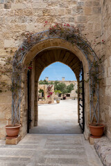 Fototapeta na wymiar Birgu, Malta, May 1, 2023. Gate leading to a courtyard with buildings inside at Fort St Angelo.
